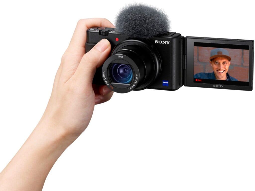 a female hand carrying a sony ZV camera