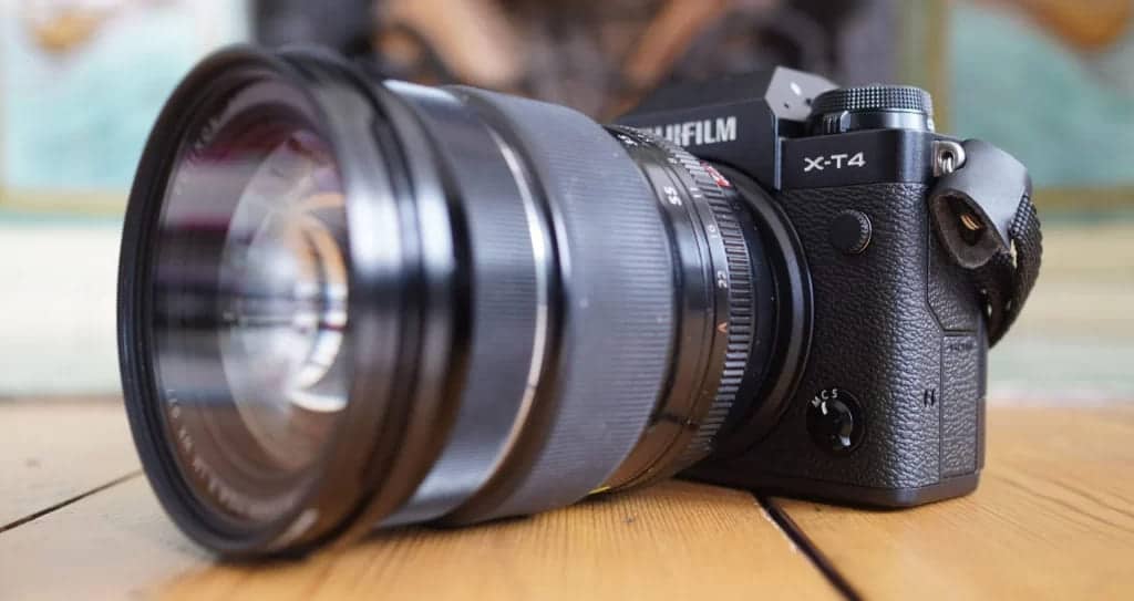 fujifilm black camera placed on a desk