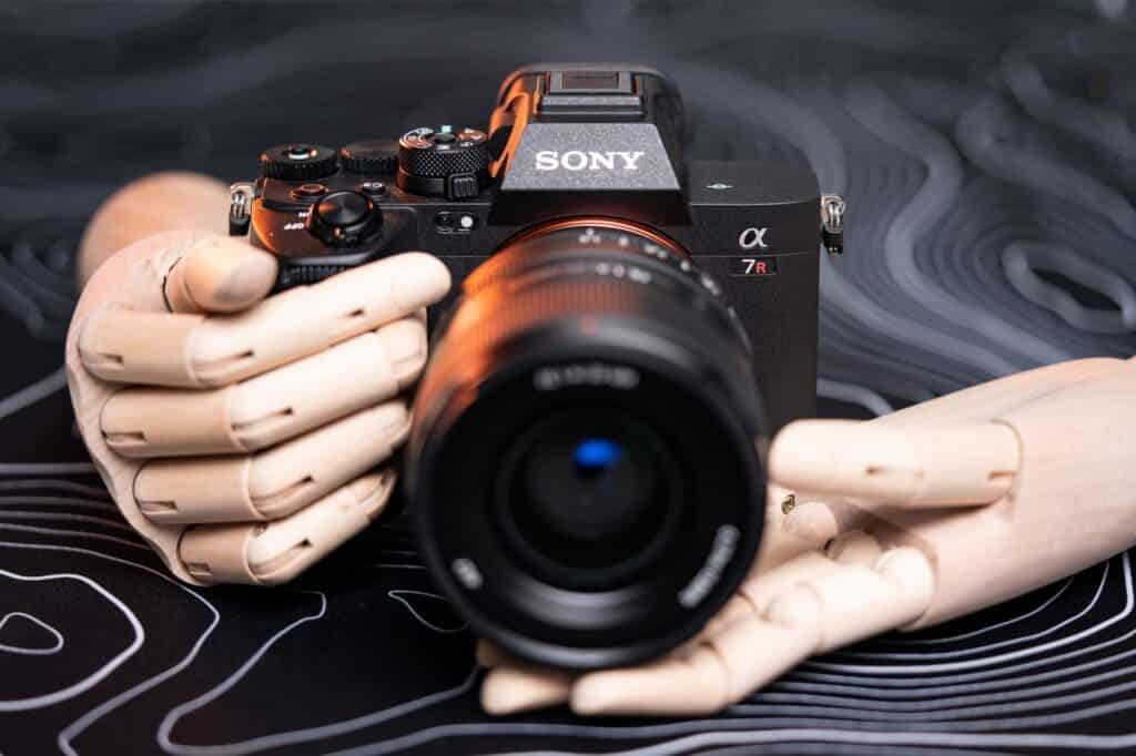 robotic hands carrying sony mirrorless camera