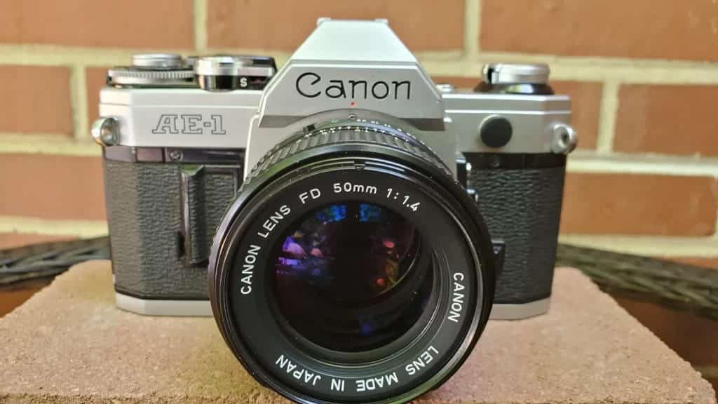 vintage Canon AE camera placed on a rough surface