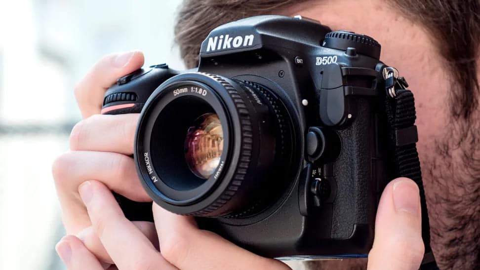 zoomed in view of a boy shooting with Nikon D