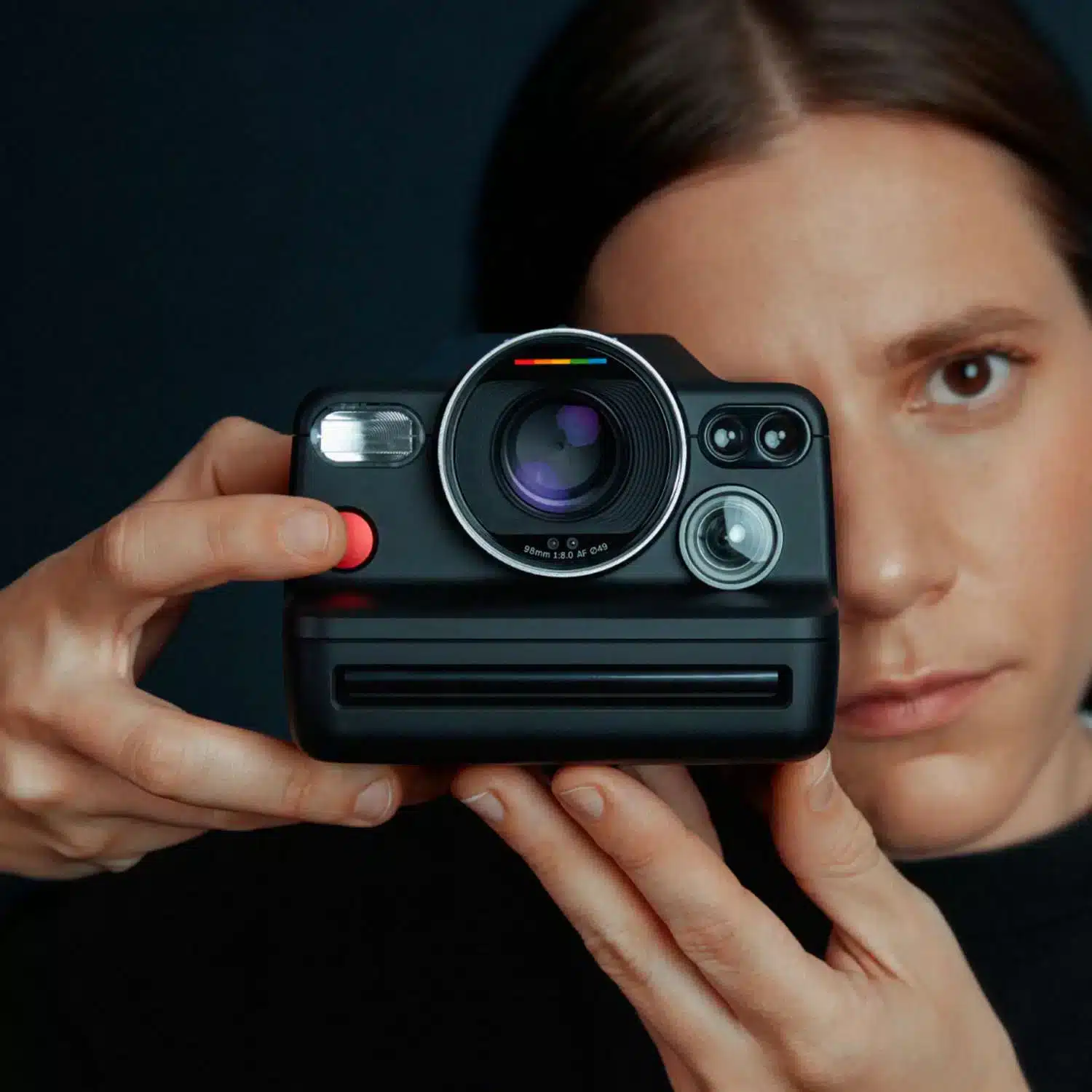 a women is capturing from the polaroid camera