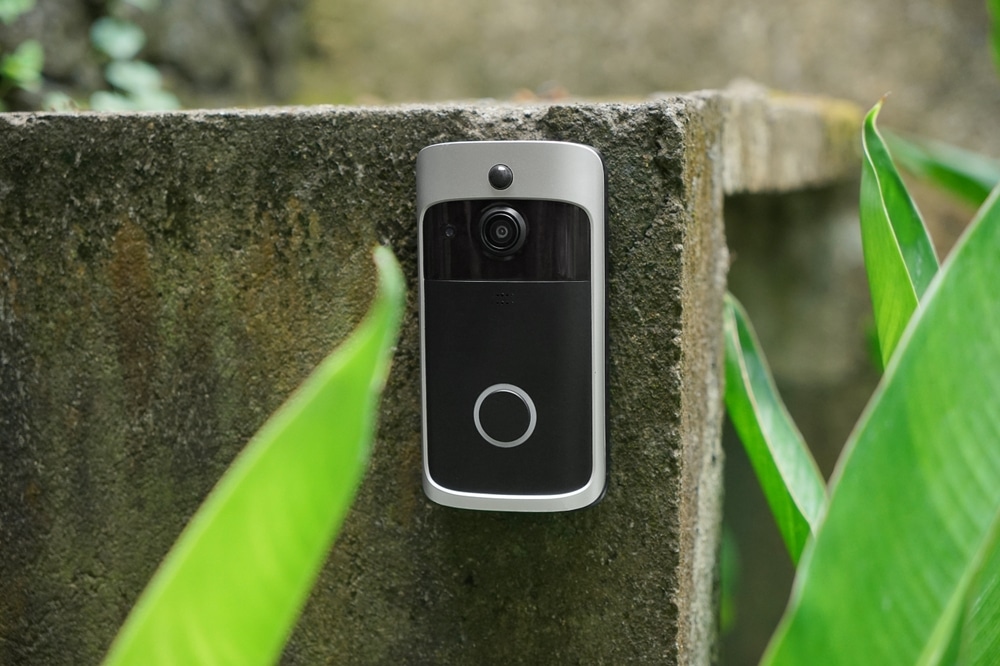 A Modern Surveillance Camera Is Installed On A Front Door