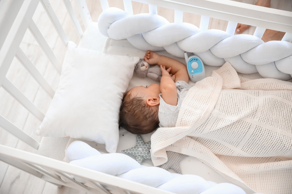 Cute Little Child With Toy And Baby Monitor Sleeping In