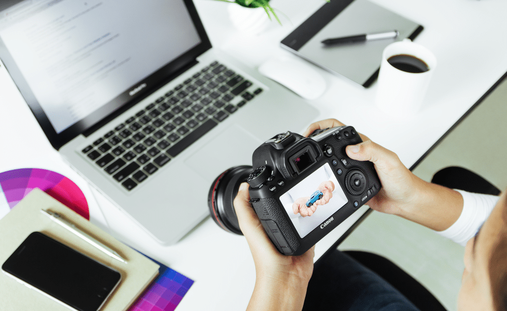 a man holding a canon camera 